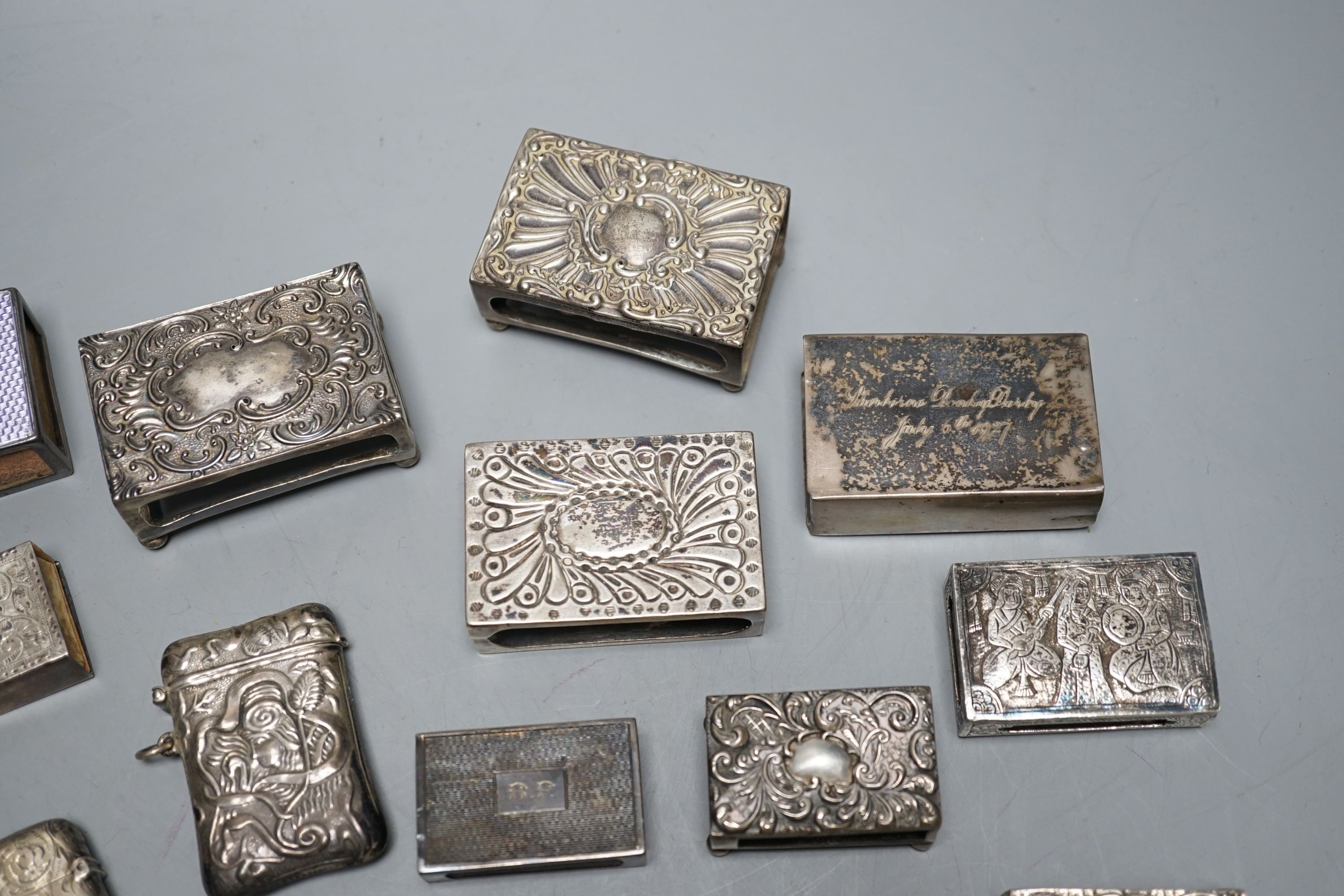 A small collection of nine mainly early 20th century silver or sterling vesta cases, largest 60mm and fourteen assorted similar silver or white metal match sleeves